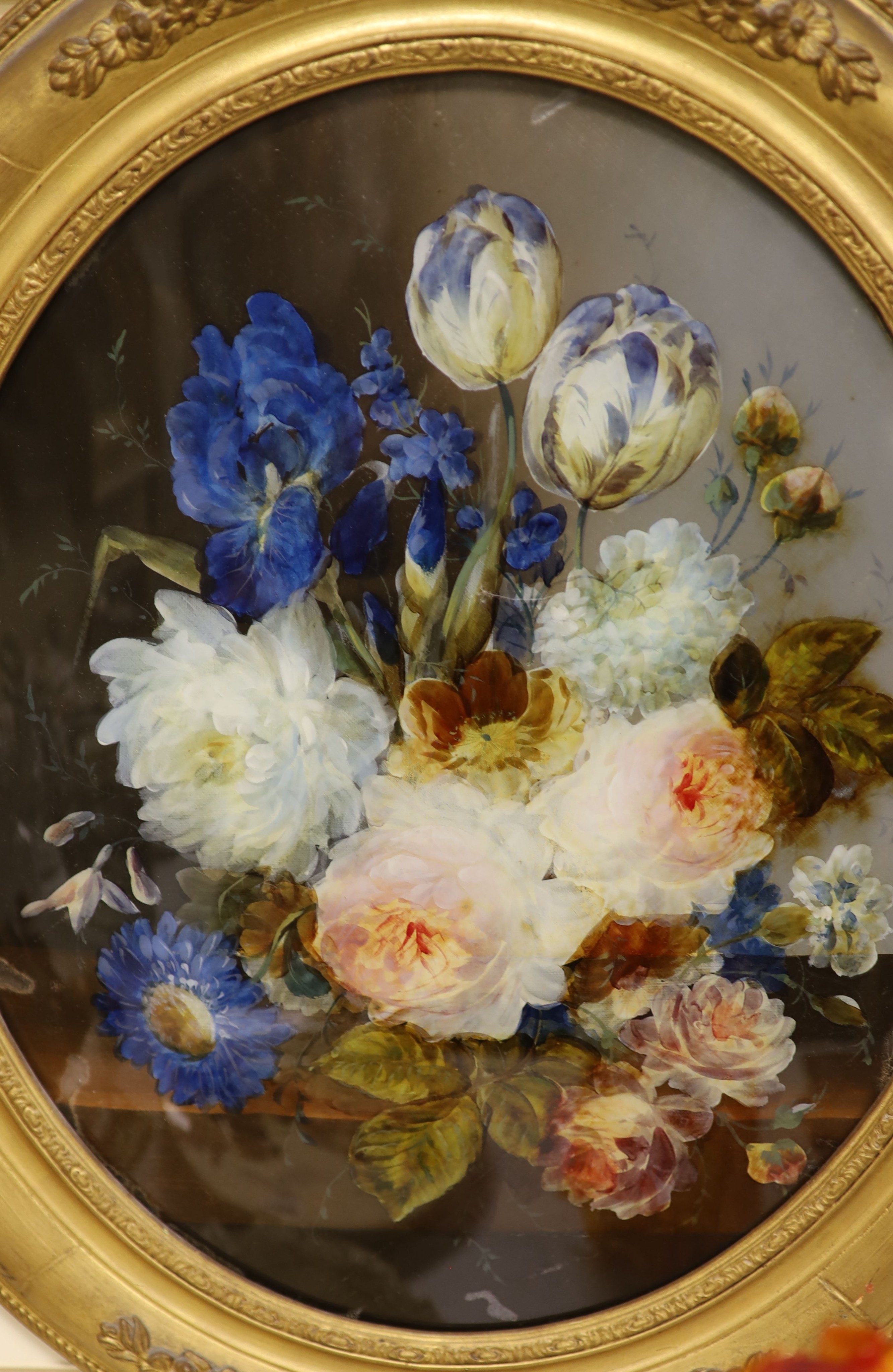 A pair of Victorian reverse painted oval glass flower paintings, 45 x 37cm.